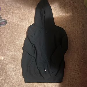 Plain black hoodie with a “c” and a heart on the sleeve